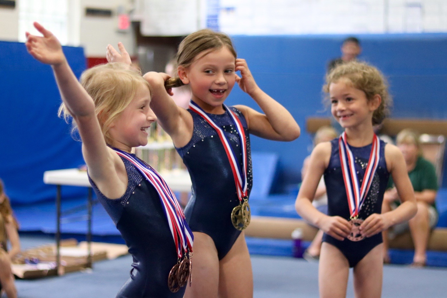 Level 1s receiving medals at a home meet